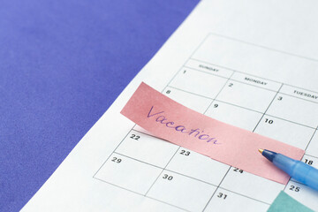 Calendar of the month and several colored adhesive notes to highlight the activities to be done. Copy space. Concept of time organization and achievement of objectives.