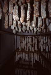 Hanging Cured Sausages in Traditional Smokehouse