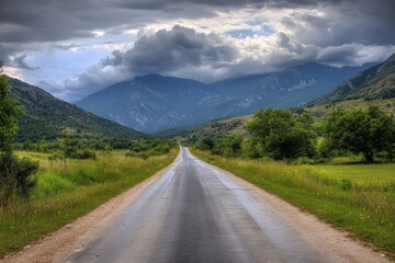 Fototapeta premium Old Highway Through Mountain Landscape under Cloudy Sky