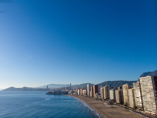 Fototapeta premium Aerial photo taken in Benidorm in Spain Alicante, showing the beautiful beach of Playa Levante and hotels, buildings, and high rise skyline cityscape.