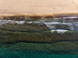 Aerial photo of the beautiful beach taken in the town of Benidorm in Spain, showing a top view of a typical Spanish beach