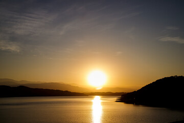 Sunset behind the mountains at El Cadillal Lake in Tucuman, Argentina