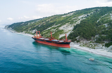 Aerial view of an abandoned bulk-carrier dry cargo ship washed ashore after a storm