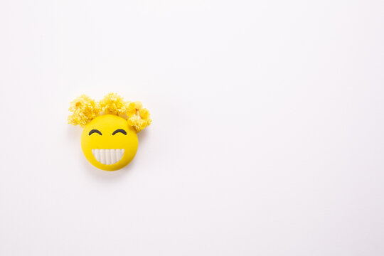 Smiling yellow face on white background. World smile day. Copy space