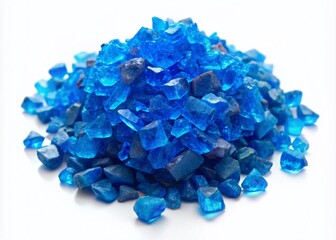 Fototapeta premium Vibrant blue crystals of copper(II) sulfate pentahydrate (CuSO4·5H2O) scattered on a white background, showcasing its