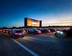  Drive-in cinema with cars – An outdoor American drive-in theater with rows of cars...