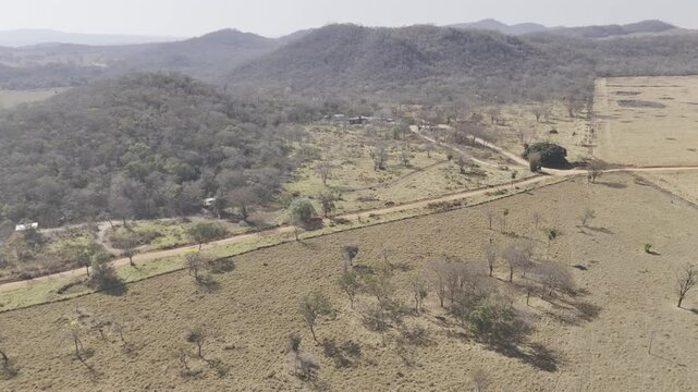 Drone flies from afar to above the welcome center to Gruta do Mimoso near Bonito, Mato Grosso do Sul, Brazil
