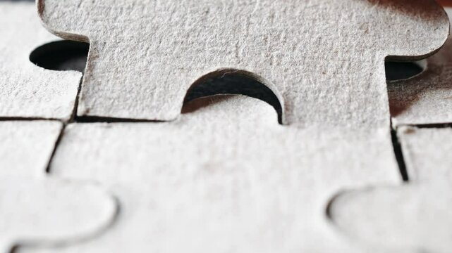 Close up hand holding pieces of jigsaw puzzle, Business solutions, success and strategy concept.