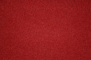 The vibrant red surface features fine grains and a smooth texture, highlighting the richness of color perfect for creative projects or background settings