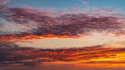 Fototapeta premium Sunset sky. Cirrocumulus and cirrostratus clouds during sunset. Beautiful dramatic sunset sky background
