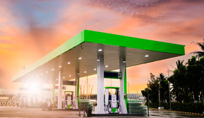 Gasoline pump nozzle sign. Fuel pump petrol station,Oil and Gas station at sunrise and orange sky .