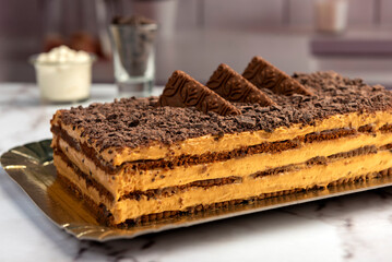 sweet dessert choco cake with chocolate cookies dulce de leche cream cheese on kitchen counter decorated with broken chocolate