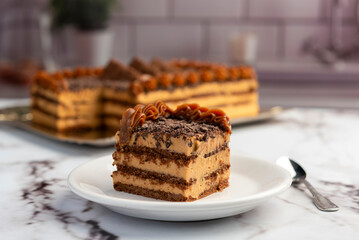 sweet dessert choco cake with chocolate cookies dulce de leche cream cheese on kitchen counter decorated with broken chocolate