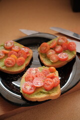 Avocado toast with cream and cherry tomatoes