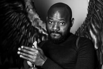 Majestic portrait of a man with angelic wings in black and white