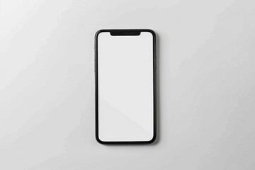 A smartphone with a blank screen sitting on a white surface