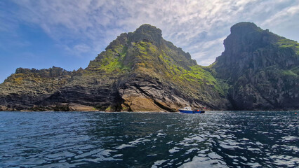 The rugged beauty of Skellig Michael unfolds in this panoramic shot, highlighting its steep cliffs and the rich history nestled within its landscape.