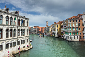 Fototapeta premium Gondola photo in Venice. Beautiful video with touristic taxi and local gondola boats cruising on the channels of Venice. Landmark landscape view of Italy.