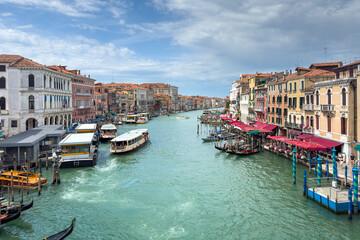 Gondola photo in Venice. Beautiful video with touristic taxi and local gondola boats cruising on the channels of Venice. Landmark landscape view of Italy.