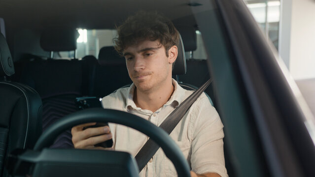 Caucasian confused sad driver upset puzzled male businessman frustrated man stressed business employer in car auto automobile parking lot traffic jam gadget addict lost problem bad news mobile phone