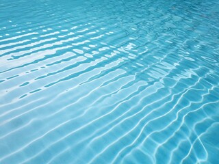 Fototapeta premium A top view photo of a swimming pool with clear blue water. The water is rippled and has a smooth texture, creating a wave-like pattern