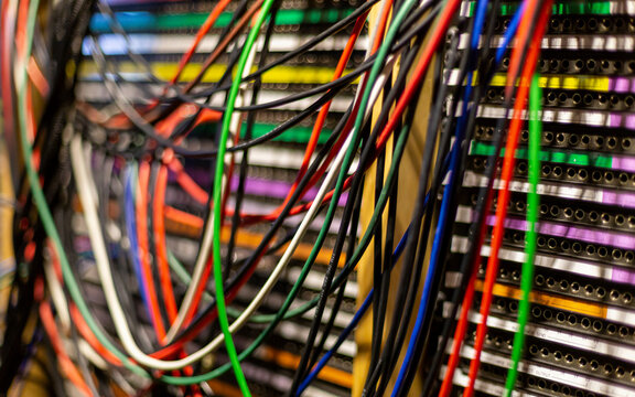 Close-up of a colorful network server cables and switches in a data center.