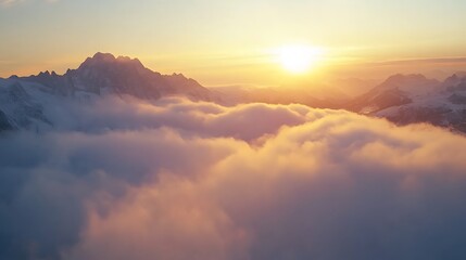 A breathtaking sunrise over mountains shrouded in clouds, highlighting nature's beauty and tranquility.