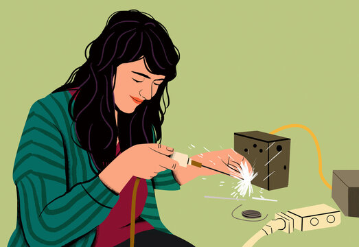 Woman soldering a component, with sparks flying from the soldering iron.
