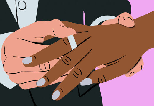 Two hands with one placing a wedding ring on another person's finger during a marriage ceremony.