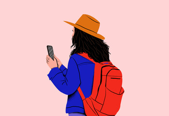 Adult with a backpack looking at a smartphone, wearing a blue jacket and orange hat against a pink background.