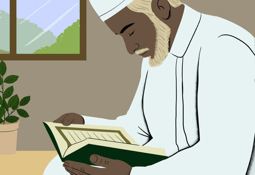 An elderly man wearing traditional Islamic attire is focused on reading the Quran indoors beside a potted plant and a window.