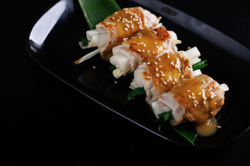 japanese pork roll grill japanese food isolate in black background