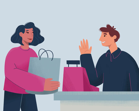 Smiling cashier hands over shopping bags to a happy customer at a checkout counter.
