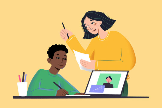 A smiling woman assists a young boy with his homework on a computer, with a photo on the screen and stationery on the table.