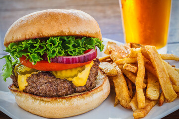 classic American cheeseburger with lettuce, tomato, onion, and pickles