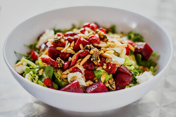 Beet salad with dried cranberries, pine nuts, and almonds