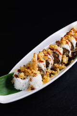 Tempura shrimp maki roll with cucumber Japanese food isolate in black background