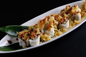 Tempura shrimp maki roll with cucumber Japanese food isolate in black background
