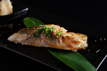Grilled Seabass with teriyaki sauce Japan fish Japanese food isolate in black background