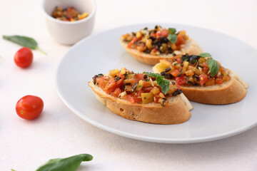 Bruschetta with Tomato and Basil Traditional toasted Italian food tomato bruschetta seasoned with spice and garnished with basil