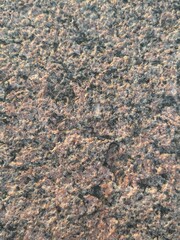 Granite stone wall close up pattern. Marble wall texture. Pink gray black color uneven background surface. Textured wall pattern