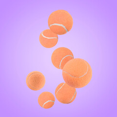 Many orange tennis balls flying on violet background