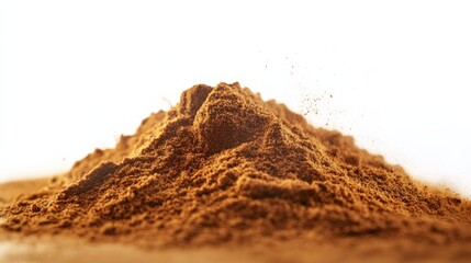 Close-up of a mound of brown cocoa powder against a white background, ideal for culinary and food-related designs and projects.