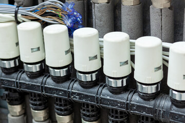 Solenoid valves on delivery pipes for underfloor heating and cooling systems.