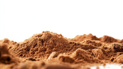 Close-up of fine brown cocoa powder against a white background, showcasing texture and color of the ingredient.