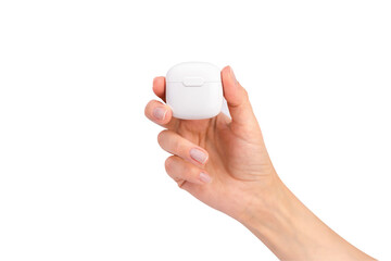 Woman's hand holding wireless headphones isolated on white background. Bluetooth headphones.