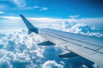 Obraz premium Sky From Airplane. Flying High Above the Fluffy Clouds in a Blue and White Sky