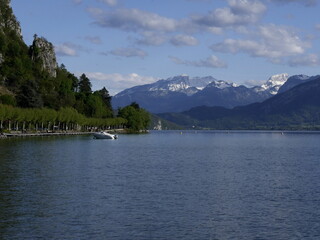 annecy lake in the afternoon, natural alpine lake surrounded by mountains in spring in haute Savoie, france