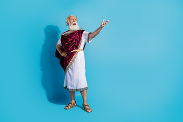 Full body photo of handsome senior male noble king speech wear ancient greek god king dress isolated on blue color background