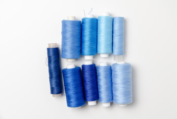 Blue thread spools on white background.